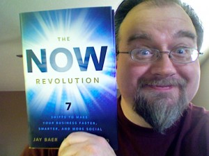 The NOW Revolution Erik Deckers holding a copy of The NOW Revolution