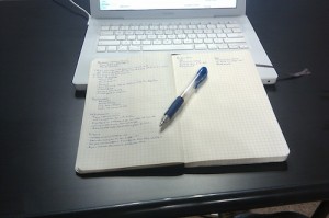 Moleskine notebook and Macbook — tools of the trade