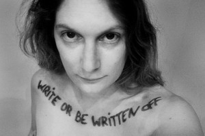 Nude woman with the words "write or be written off" written across her front shoulders